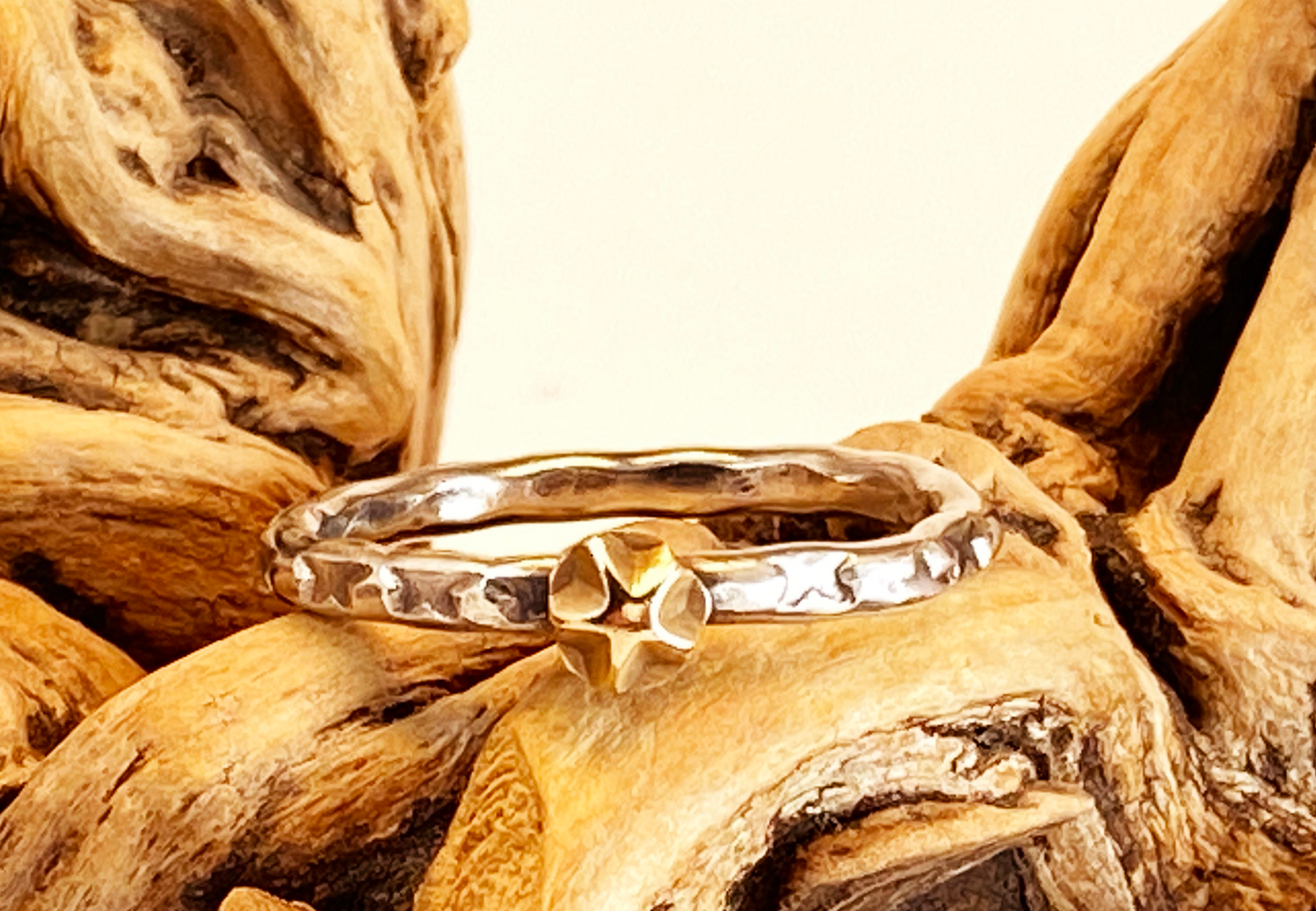 One-of-a-kind hand-crafted stacker ring.  Unique Sterling Silver band is adorned with random star stamp patterns 14k gold star embellishment Beautiful alone or with other rings Ring size 7-1/4 Style: rustic, boho, funky, organic, earthy yet elegant