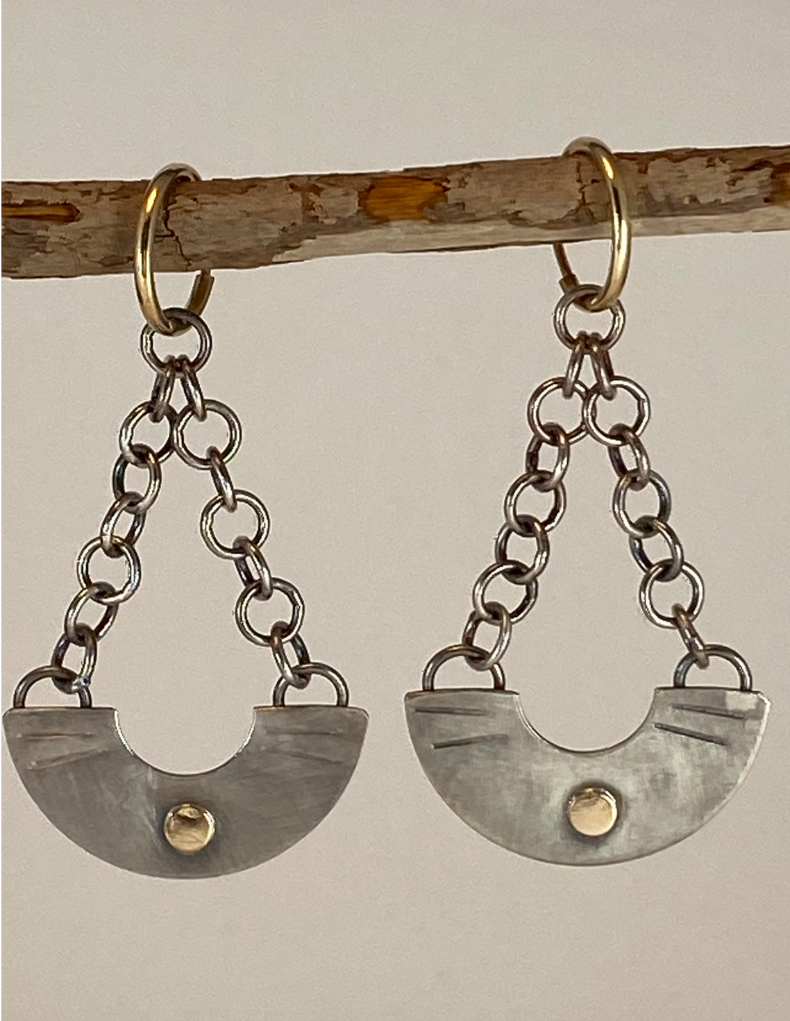One-of-a-kind hand-crafted earrings. Elegant half-circle vessel shape sterling silver earrings 14k gold high sheen accents Hand-stamped embellishments Hung with silver chain from small 14k hoops Style: rustic, boho, elemental, earthy yet elegant