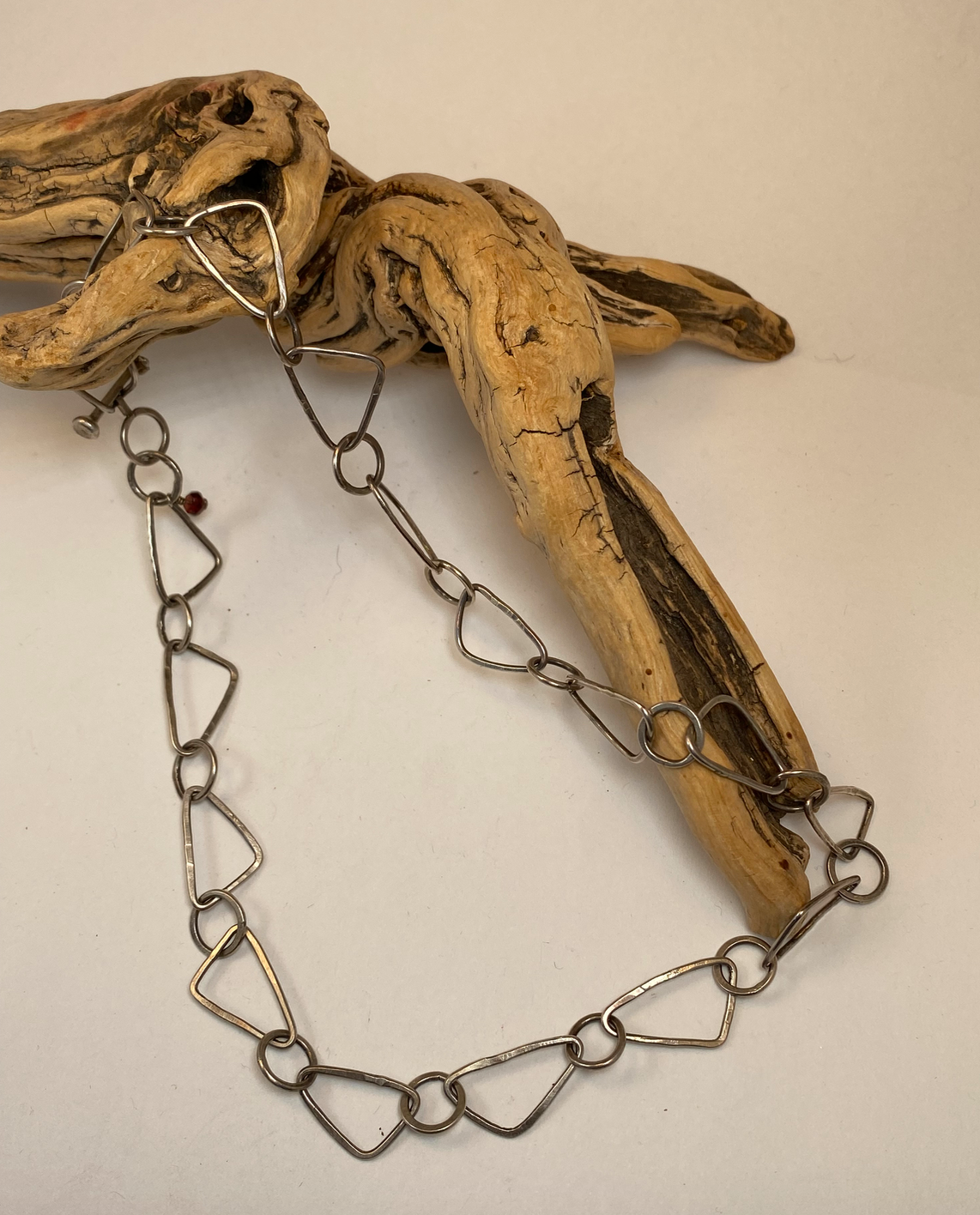 Each link of this sterling silver chain was lovingly formed, soldered, forged and finished by hand.  Unique triangle-shaped links are dynamic and draw attention in an understated way. Hand-crafted bar clasp is unique to this piece.  19" long.  Style: Organic, Boho, Rustic, Wabi-Sabi, Natural, Funky, Artsy Earthy yet Elegant