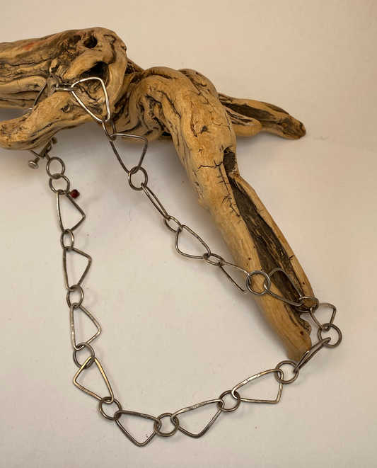 Each link of this sterling silver chain was lovingly formed, soldered, forged and finished by hand.  Unique triangle-shaped links are dynamic and draw attention in an understated way. Hand-crafted bar clasp is unique to this piece.  19" long.  Style: Organic, Boho, Rustic, Wabi-Sabi, Natural, Funky, Artsy Earthy yet Elegant