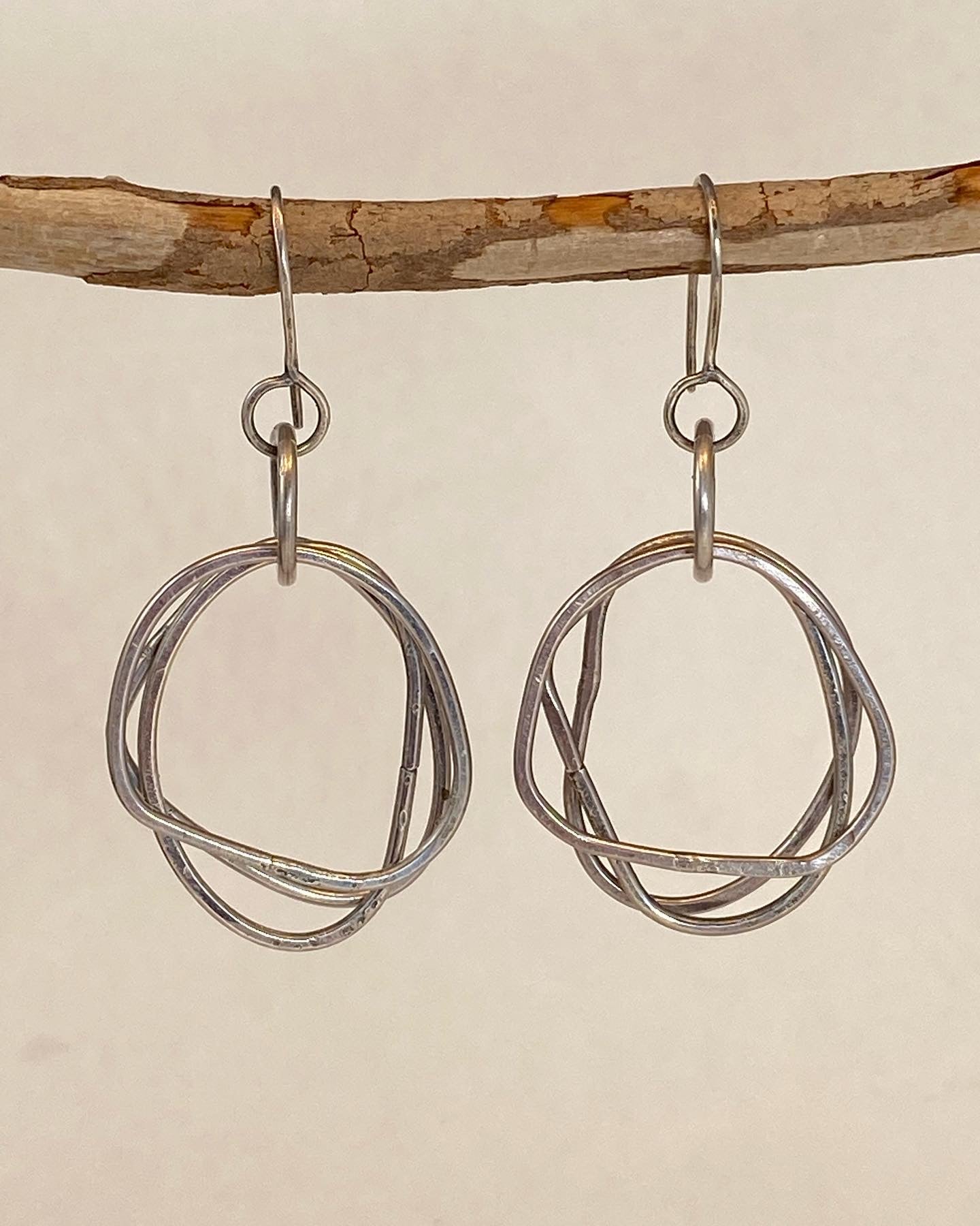 Unique design, hand-crafted sterling silver earrings. Organic shape with clean design. Lightweight. Earrings dance - feel great on!  A flattering shape for almost any face. Handmade ear wire. Each hoop is approx. 1" long; length of drop from ear wire is approx. 1.5". Style: organic, rustic, boho, elemental, earthy yet elegant MATCHING CHAIN NECKLACE AVAILABLE