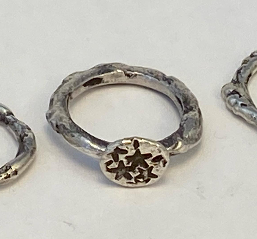 One-of-a-kind hand-crafted ring.  Unique fused sterling silver ring Lone star design stamped on silver "stone" Women's size 5-1/2 Style: rustic, boho, organic, funky, earthy yet elegant