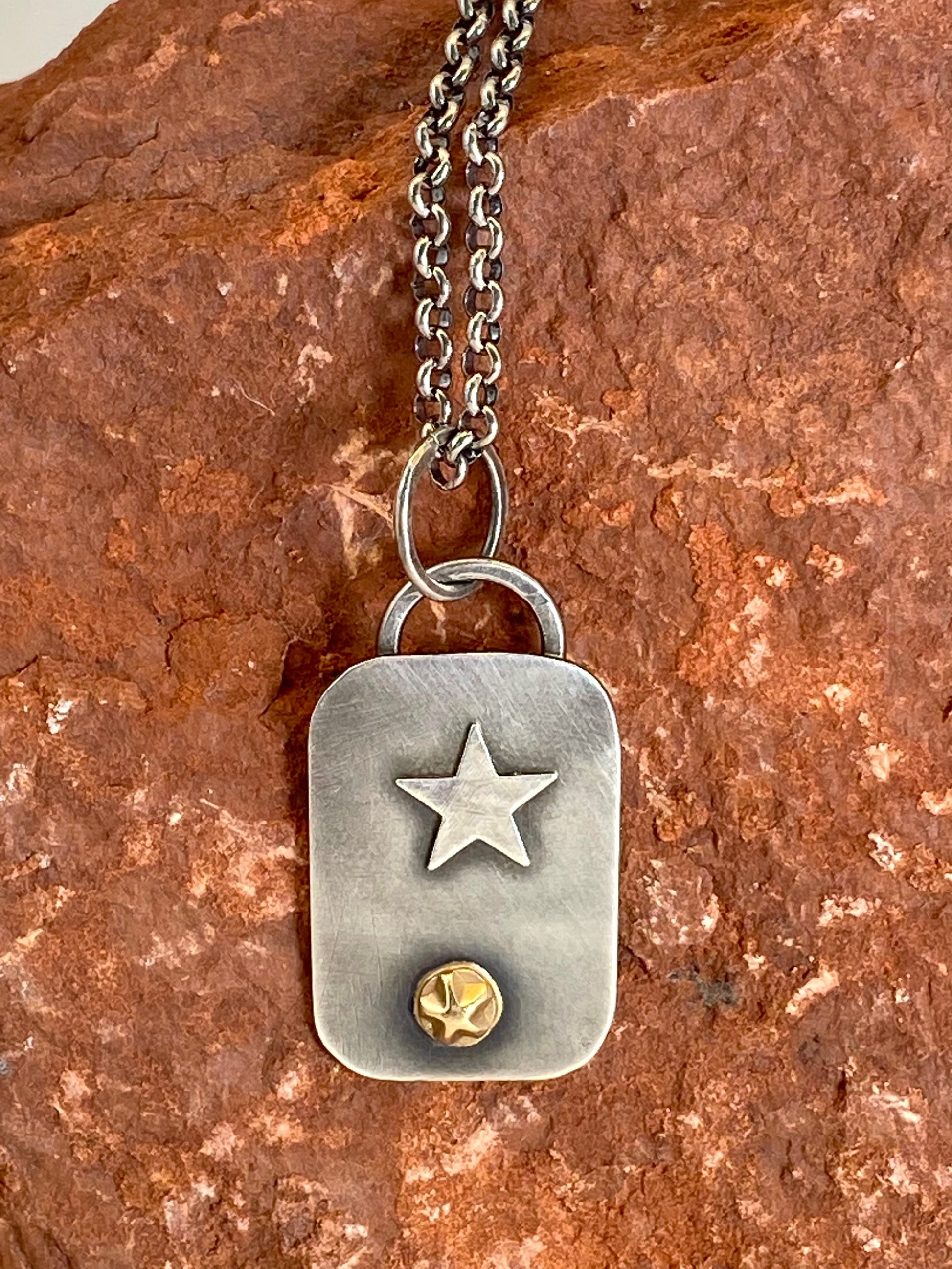Hand-crafted, one-of-a-kind sterling silver pendant featuring 14k gold star accent and sterling pentacle. 19" sterling silver rolo chain with a handcrafted clasp. 1" x 11/16"