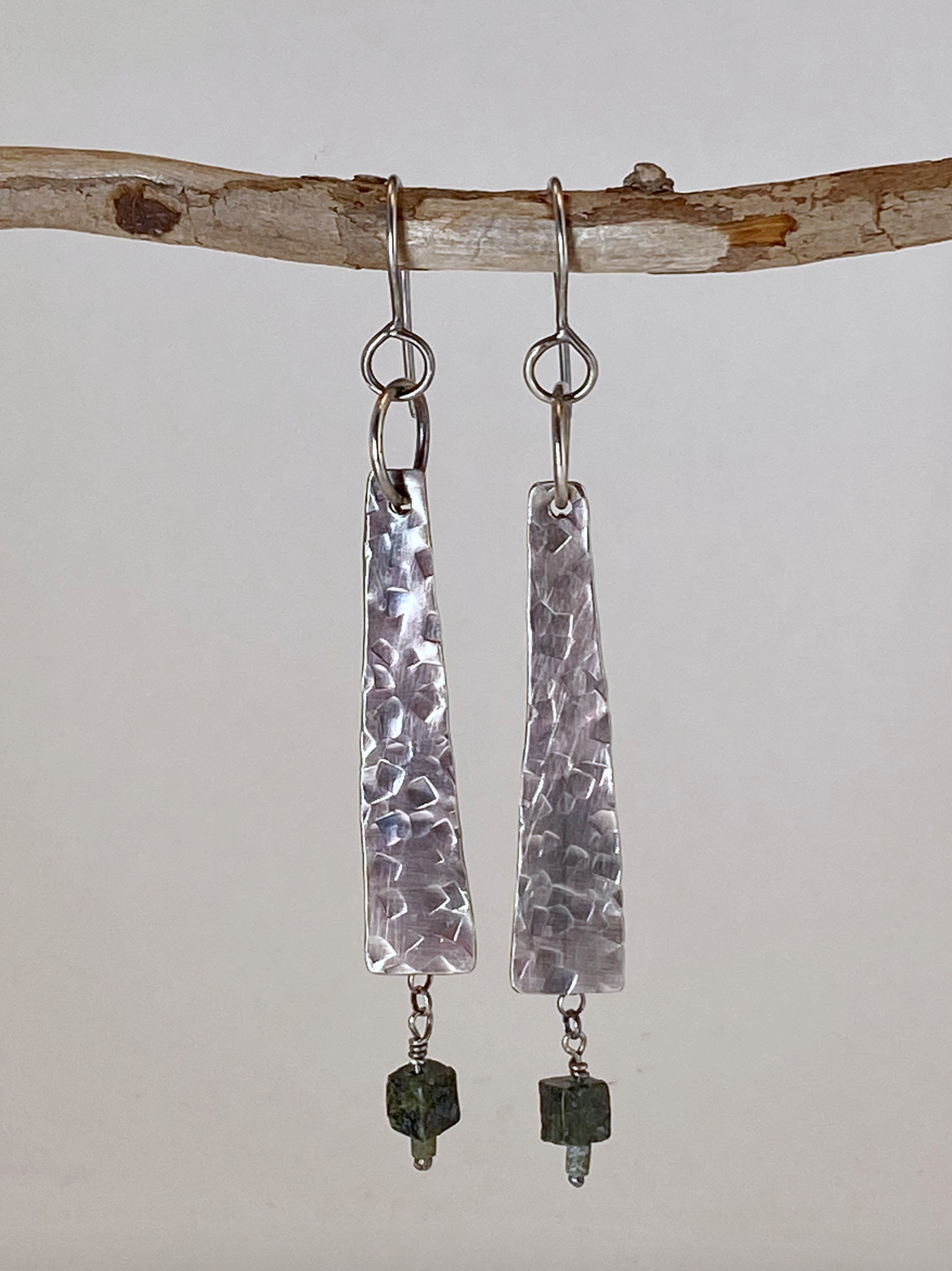 One-of-a-kind hand-crafted earrings. Evocative long sterling silver tablet-shaped earrings. Earrings dance with chain dangles behind. Serpentine bead drops. Hand-stamped texture. A flattering shape for almost any face. Stellae are 1-1/5" long x 3/8" wide at base. Handmade ear hook and ring add length. Style: rustic, boho, elemental, earthy yet elegant