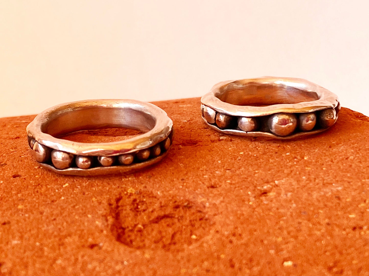 STACK OF TWO PEAPOD RINGS - Two one-of-a-kind hand-crafted sterling silver rings. Outer band wraps around interior sterling silver or antique bronze "peas." Can be ordered in any ring size. Style: rustic, boho, funky, organic, earthy yet elegant.