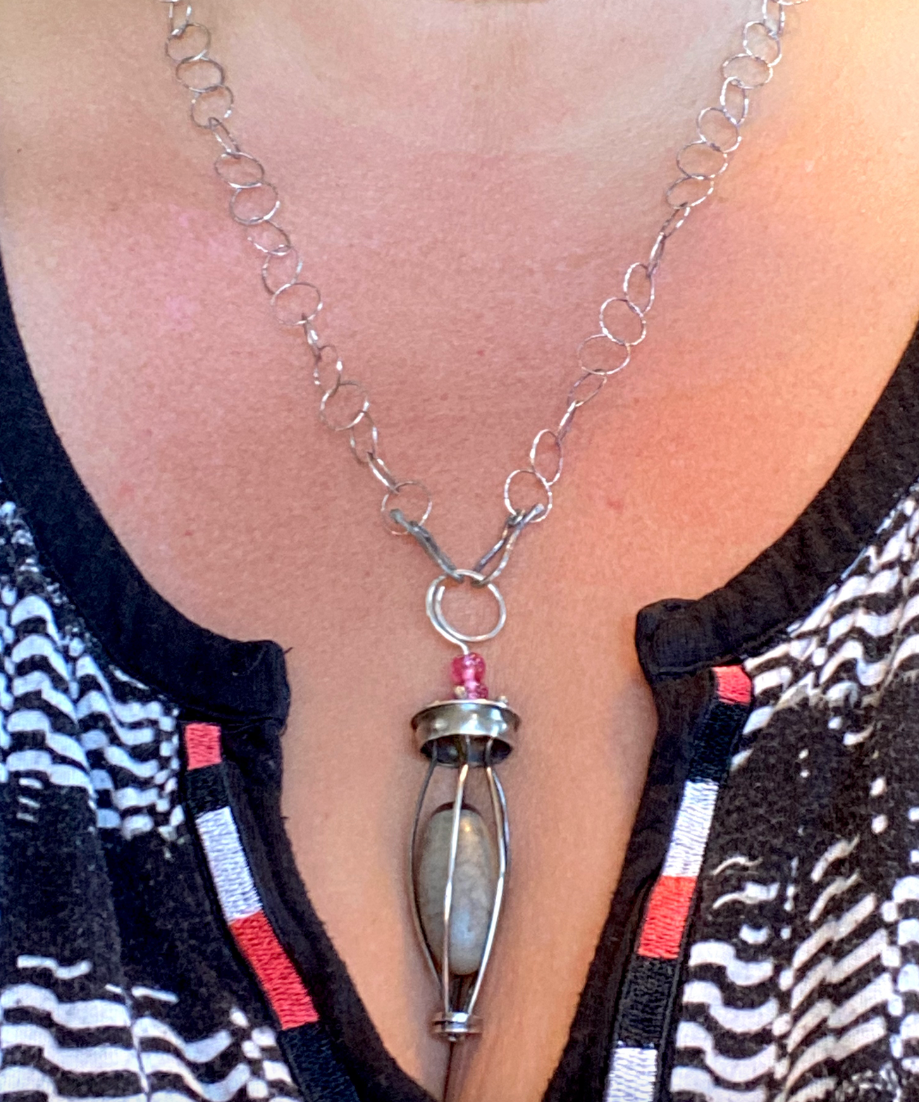 Lingam stone in sterling silver cage with adjustable length sterling silver chain - up to 24" - that can attach in front or in back, with unique handcrafted clasps .