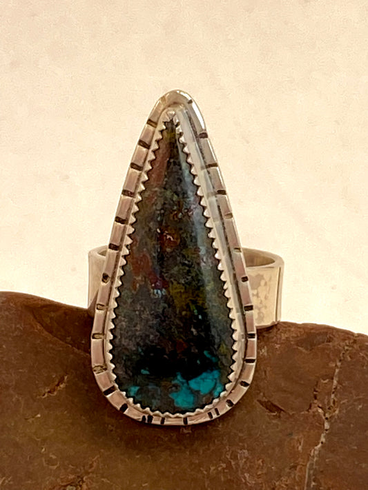 One-of-a-kind hand-crafted ring with chrysocolla stone. Backplate and band are textured with stamped line patterns.