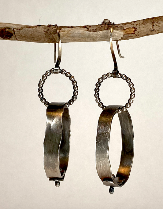 One-of-a-kind hand-crafted sterling silver hoop earrings.  Bead wire rings hold large hand-forged (hammered) hoops with ball-head pins closing them.  Length under ear wire: 1-3/4"  Style: rustic, boho, funky, earthy yet elegant
