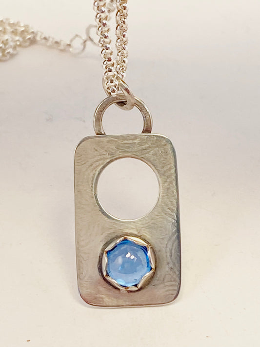 Hand-crafted, one-of-a-kind necklace sterling silver pendant featuring London Blue Topaz set in a scalloped bezel on a lightly textured surface, with accent hole.  