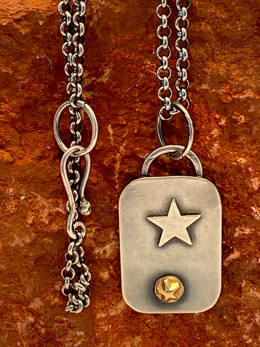 Hand-crafted, one-of-a-kind sterling silver pendant featuring 14k gold star accent and sterling pentacle. 19" sterling silver rolo chain with a handcrafted clasp. 1" x 11/16"