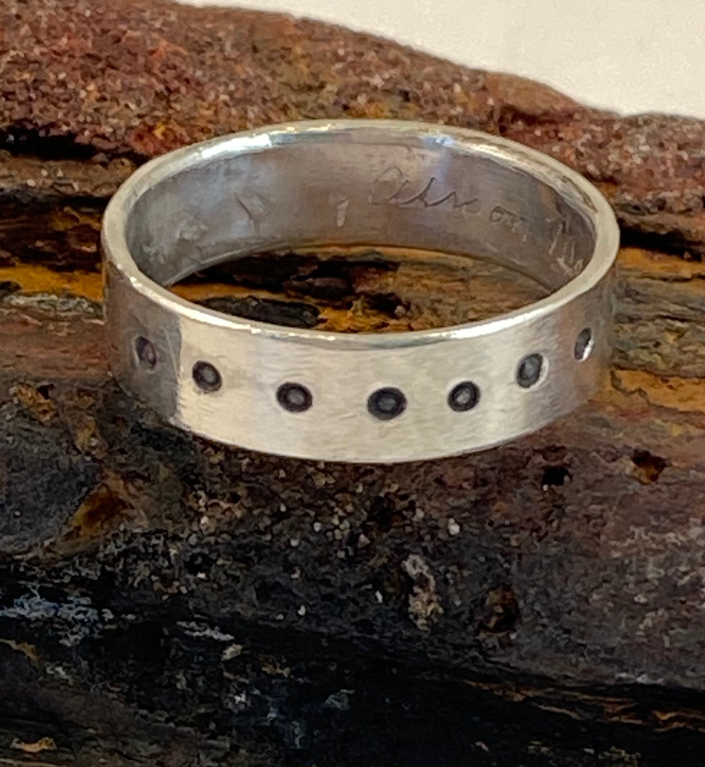 One-of-a-kind hand-crafted sterling silver "cigar band" ring. Band is adorned with an accent star, and with dots stamped around the ring. Ring size 8-1/4. Style: rustic, boho, funky, organic, earthy yet elegant.