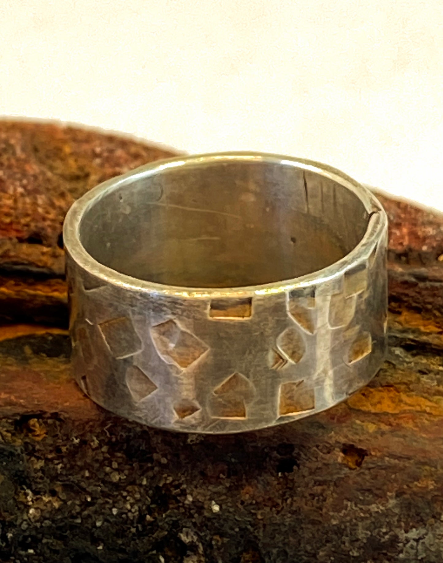 One-of-a-kind hand-crafted sterling silver "cigar band" ring.      Band is beautifully textured with squarish organic shapes.     Gorgeous organic patina that will evolve with you as you wear it.      Ring size 5-1/4.      Style: rustic, boho, funky, organic, earthy yet elegant.