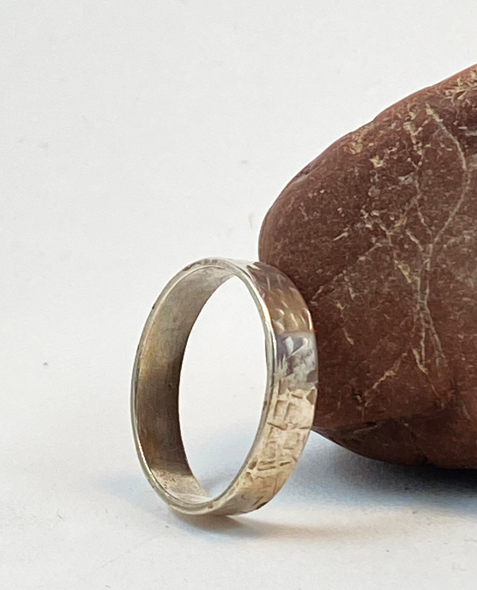 One-of-a-kind hand-crafted ring.  Unique Sterling Silver band is adorned with random stamp patterns Ring size 11-1/2 Style: rustic, boho, funky, organic, earthy yet elegant