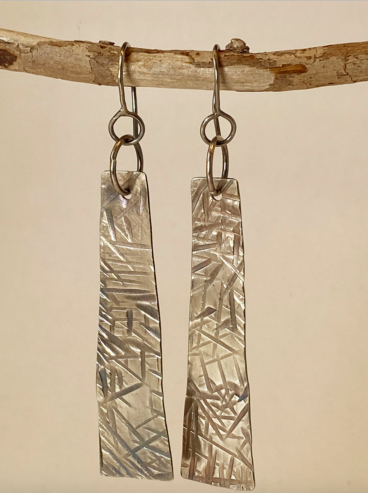 One-of-a-kind hand-crafted earrings.  Evocative long sterling silver tablet-shaped earrings. Hand-stamped embellishments. A flattering shape for almost any face. Stellae are 2" long x 1/2" wide. Handmade ear hook and ring add length.  Style: rustic, boho, elemental, earthy yet elegant